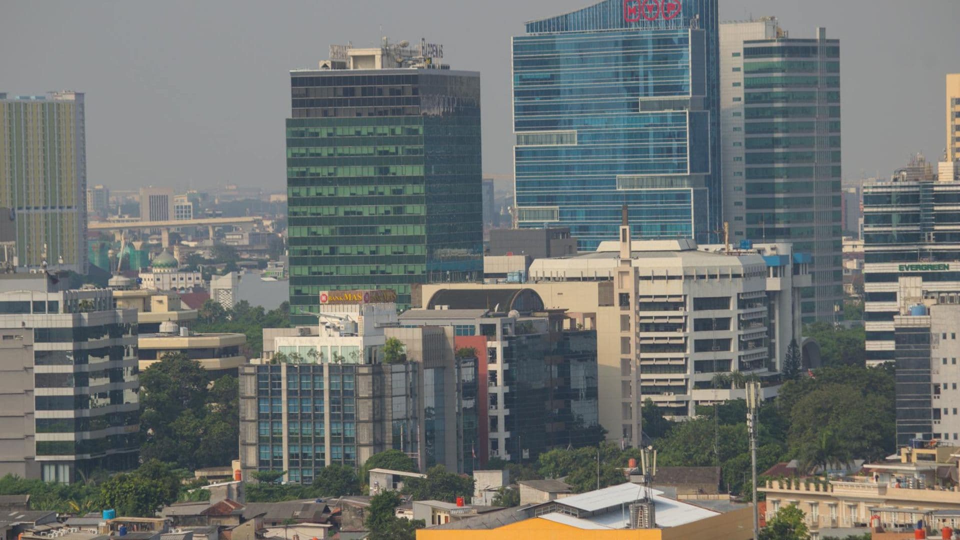 Aerial view of Jakarta's urban skyline showcasing modern skyscrapers and bustling city life.
